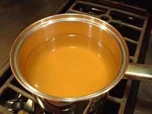 Pour chicken broth into a saucepan