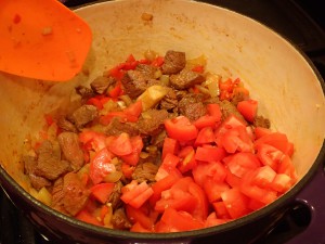 Stir in beef and tomatoes