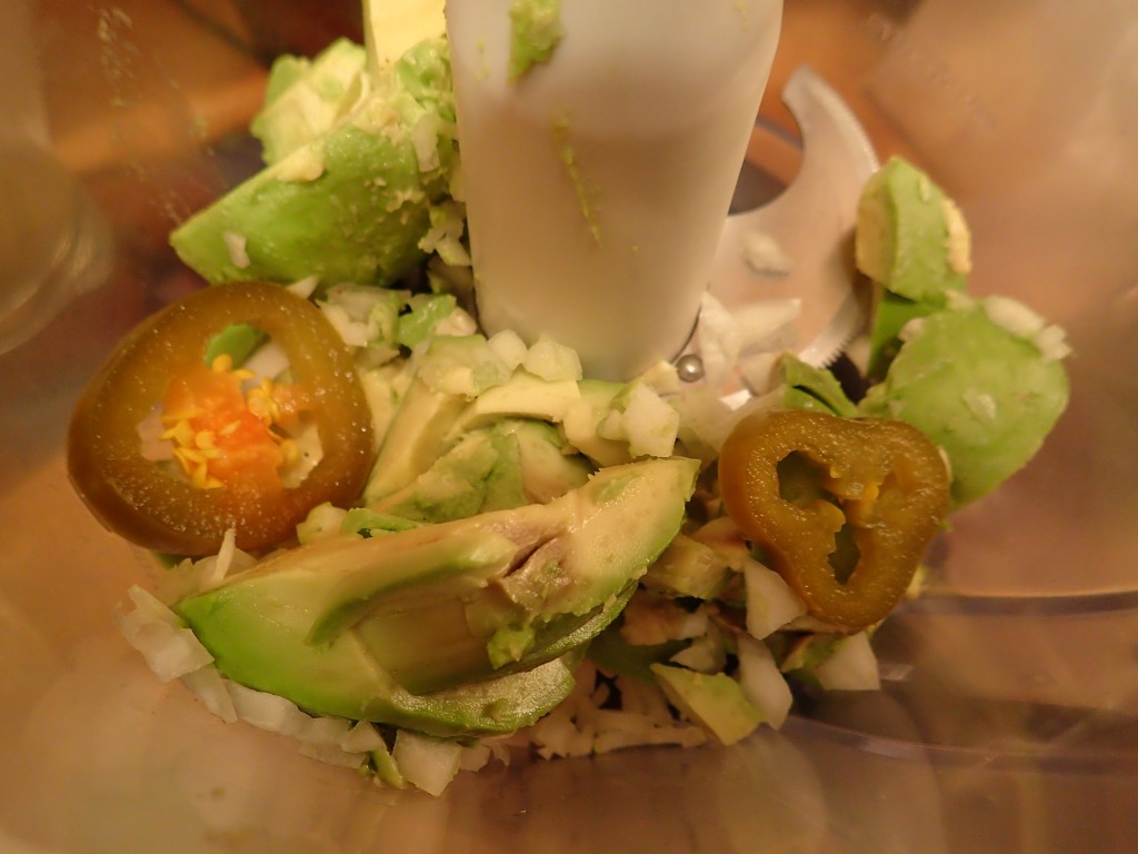 Add avocado, onions, garlic and jalapeno peppers to food processor