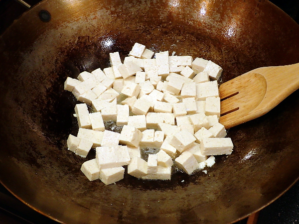 Add tofu to wok