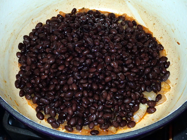Pour in 3 cans of black beans
